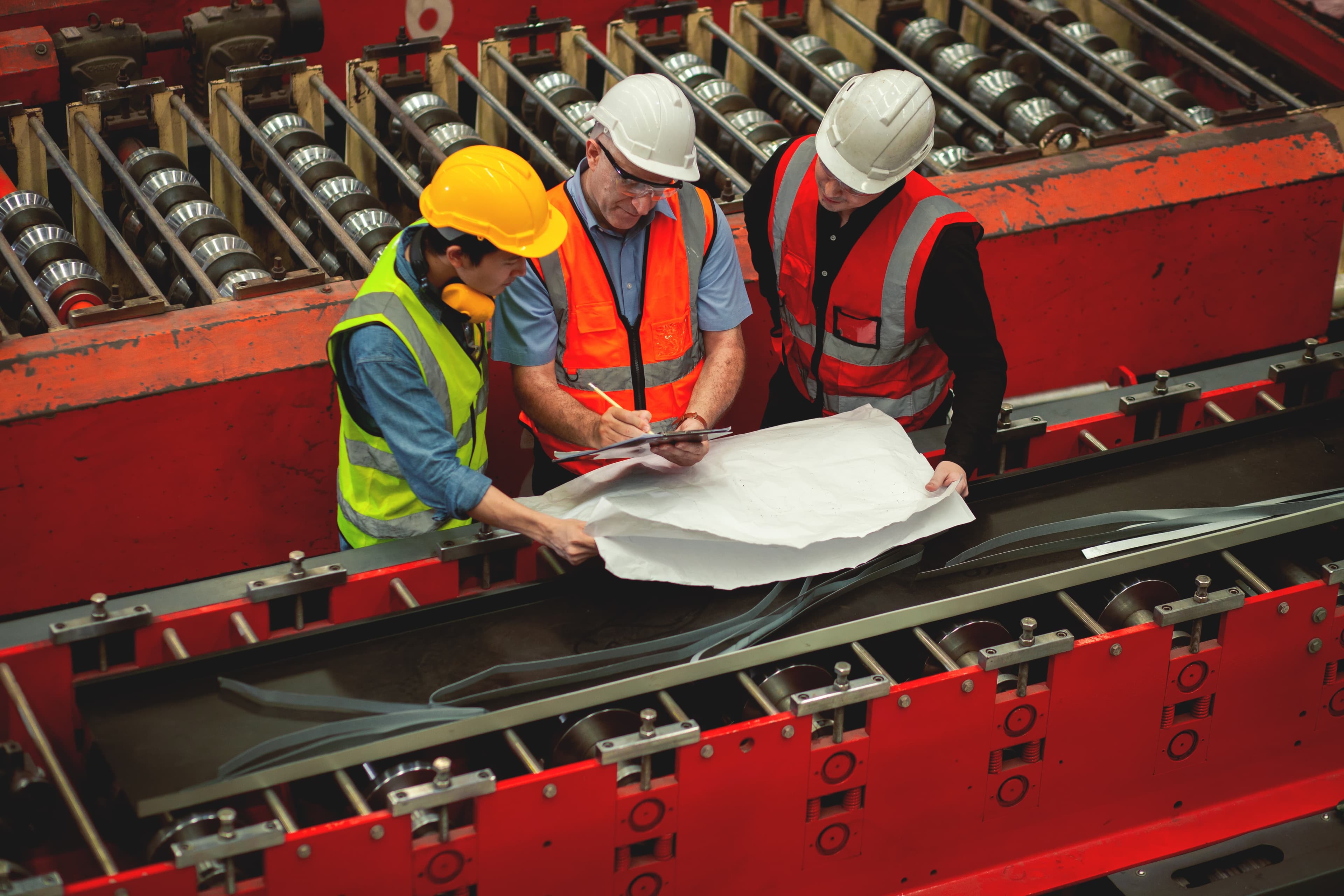 Engineers reviewing documentation on an industrial floor